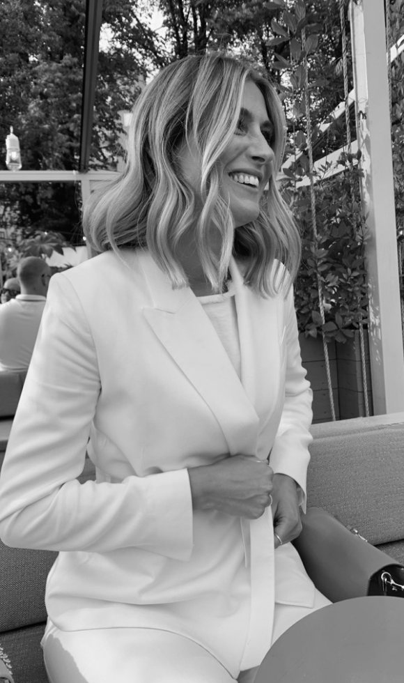 Portrait of Angelica Bjuvgård smiling, wearing a white blazer